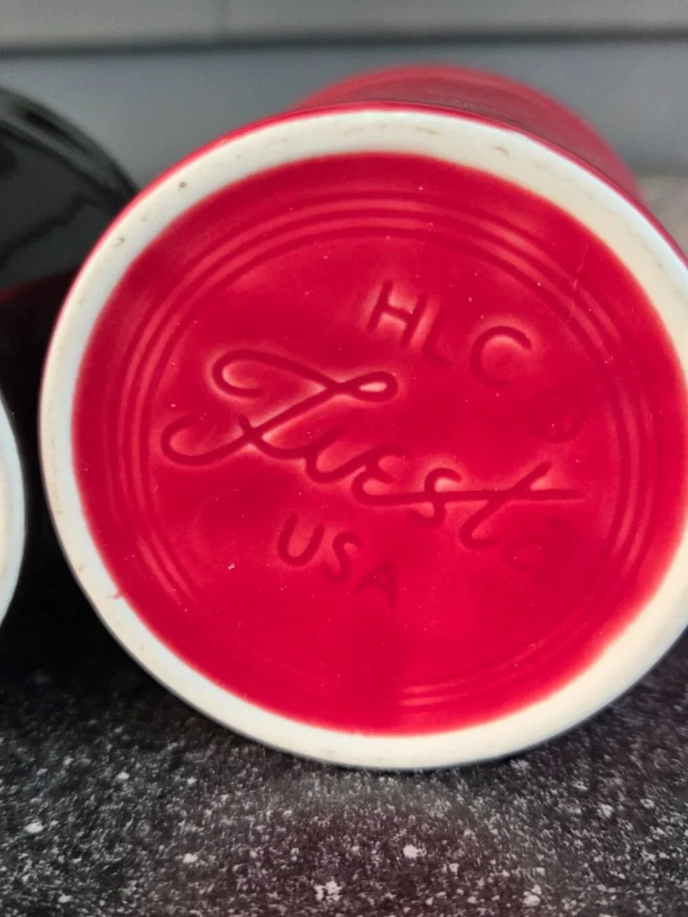 Fiestaware ceramic mugs in black and red with a ring handle, 10.25 oz capacity.